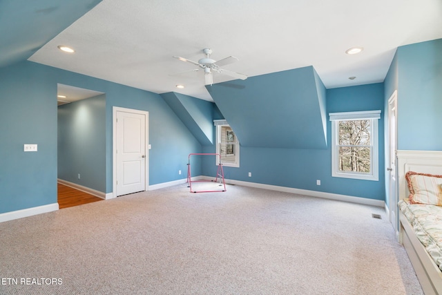 bonus room featuring ceiling fan, lofted ceiling, and light carpet