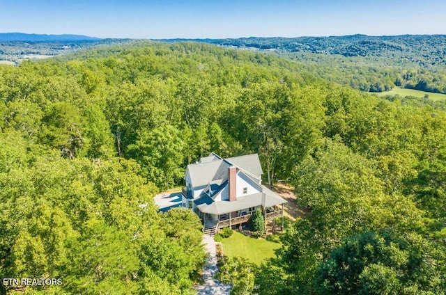 birds eye view of property with a forest view