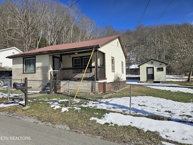 view of front facade featuring covered porch and a storage unit