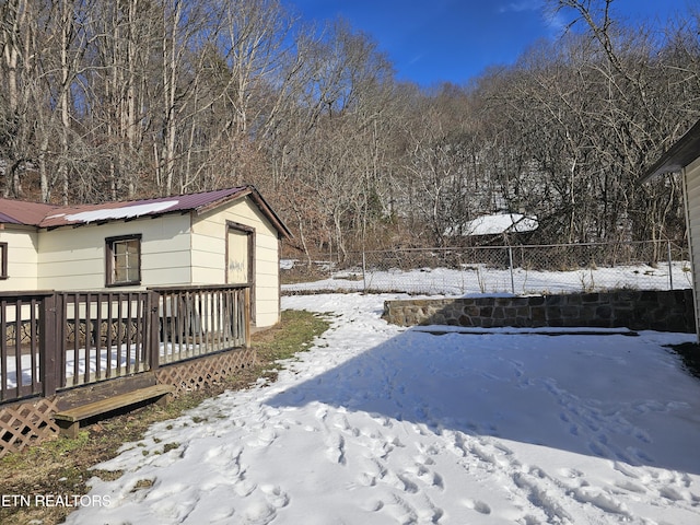 snowy yard with a wooden deck