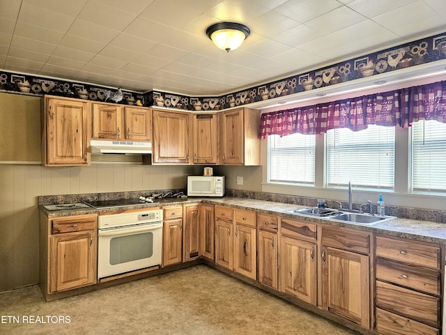 kitchen featuring white appliances and sink