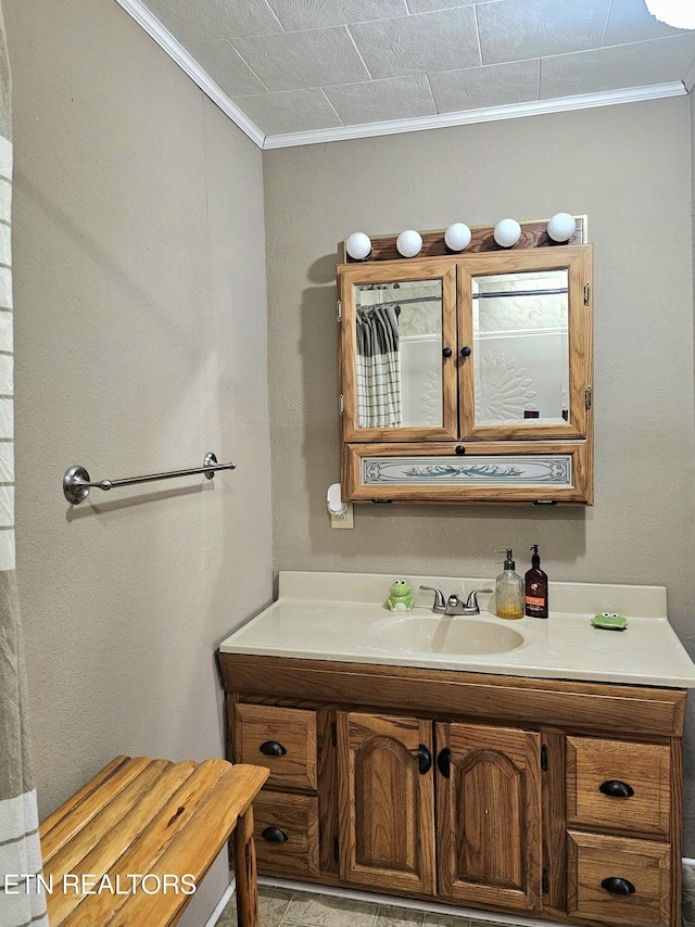 bathroom featuring crown molding and vanity