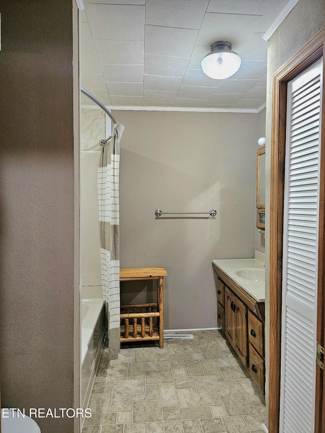 bathroom featuring ornamental molding, vanity, and shower / washtub combination