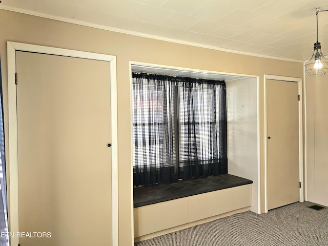 interior space featuring light carpet and ornamental molding