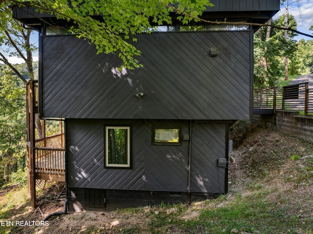 rear view of house featuring a deck