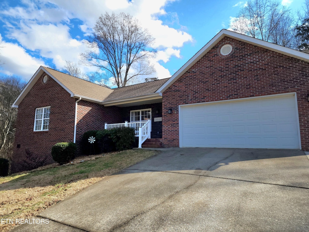 view of front property with a garage and a porch