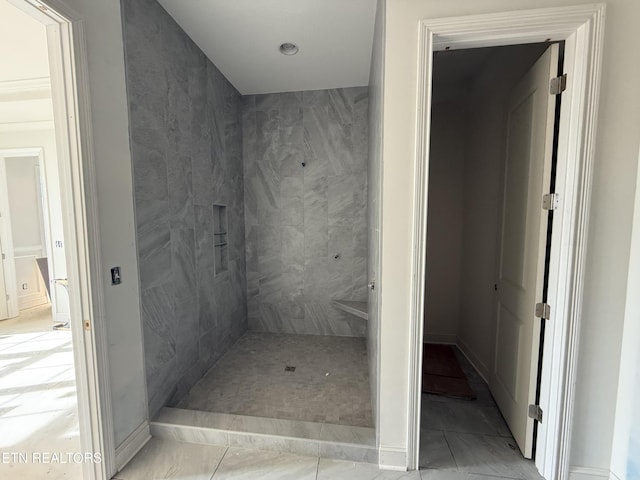 bathroom with tiled shower