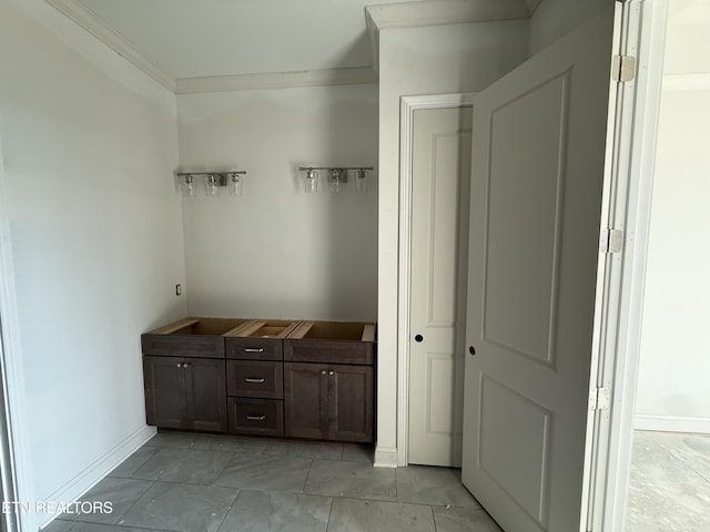 mudroom featuring crown molding and baseboards