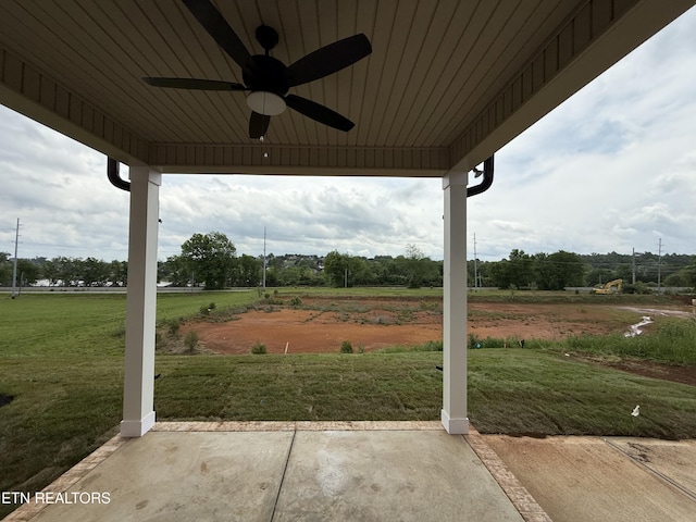 view of patio / terrace with a ceiling fan and a rural view