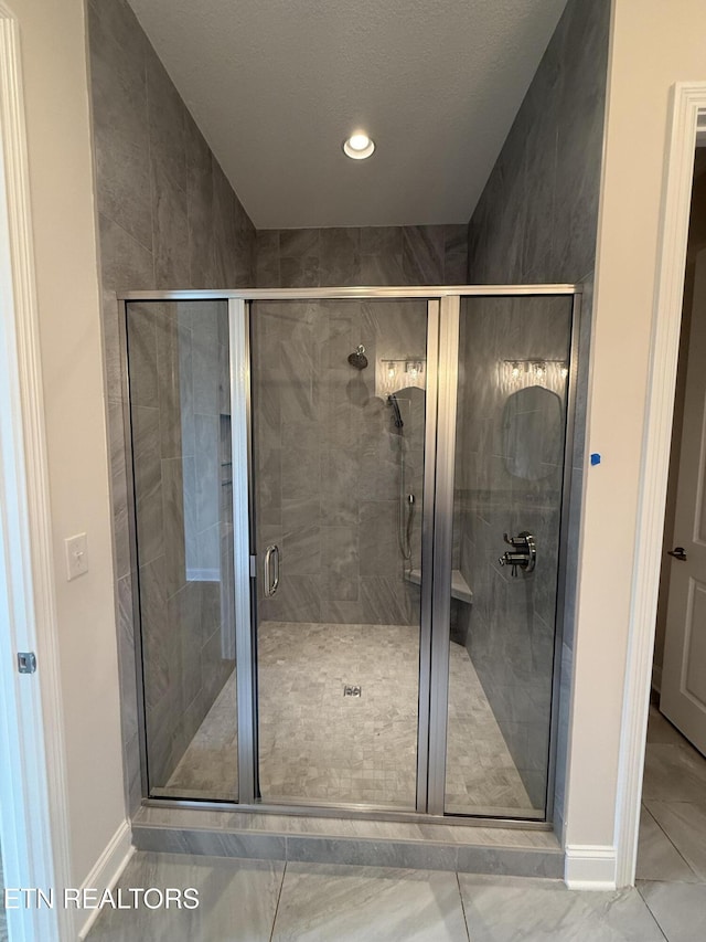 full bathroom with recessed lighting, baseboards, and a shower stall