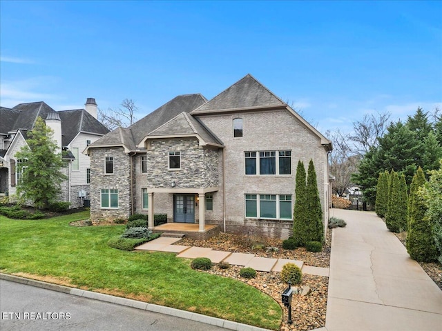 french provincial home featuring a front lawn