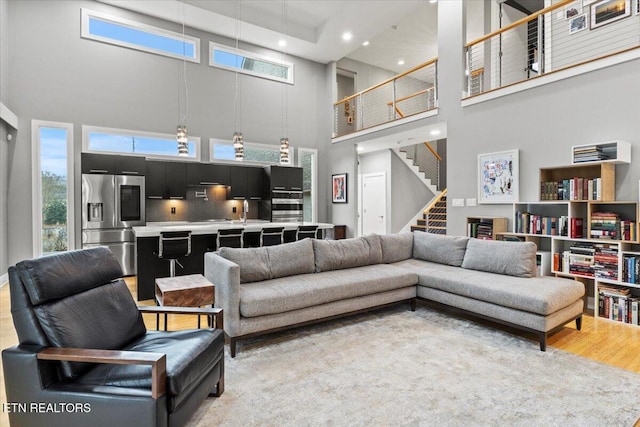 living room featuring hardwood / wood-style floors and a high ceiling