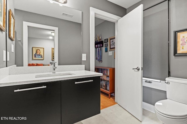 bathroom with vanity and toilet