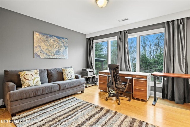 office space with light hardwood / wood-style flooring