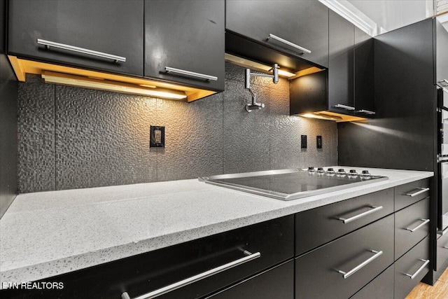 kitchen featuring black electric stovetop and backsplash