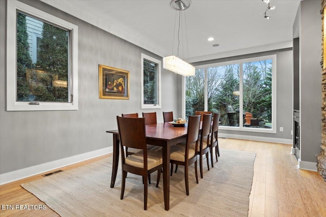 dining space with light hardwood / wood-style flooring