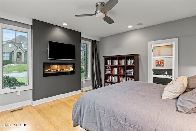 bedroom featuring hardwood / wood-style floors and ceiling fan