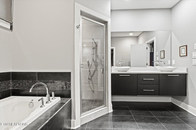 bathroom featuring independent shower and bath, vanity, and tile patterned flooring