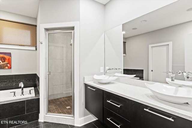 bathroom featuring tile patterned floors, vanity, and shower with separate bathtub