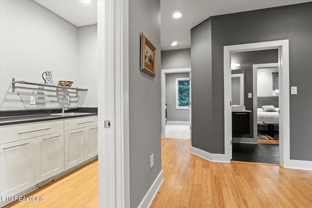 hall featuring sink and light hardwood / wood-style floors