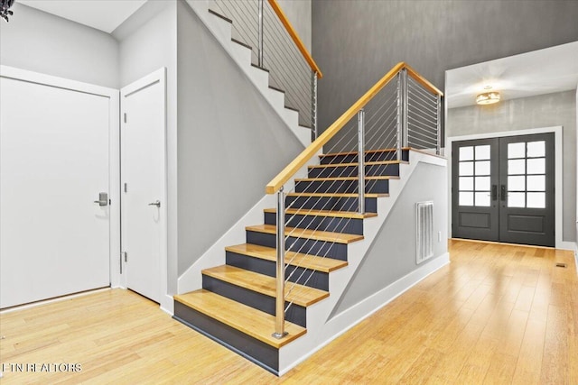 entryway featuring wood-type flooring and french doors