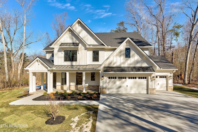 modern farmhouse style home with a front yard and covered porch