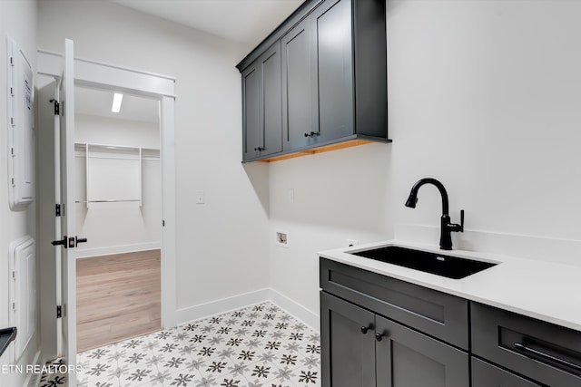 laundry area featuring cabinets, sink, and washer hookup