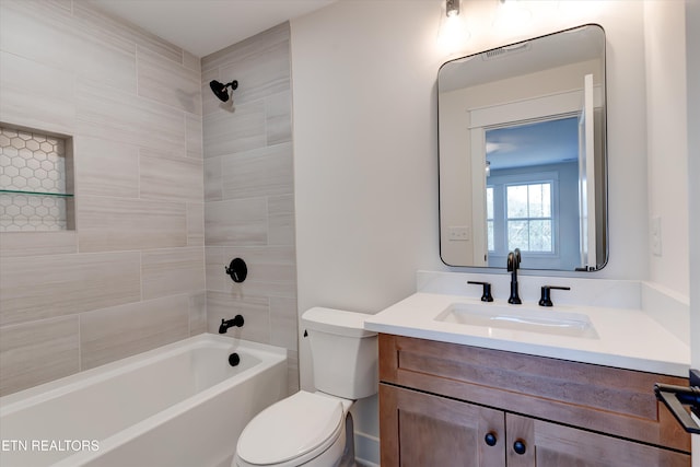 full bathroom with tiled shower / bath, vanity, and toilet