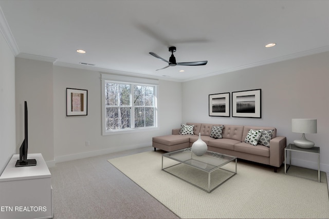 carpeted living room with crown molding and ceiling fan