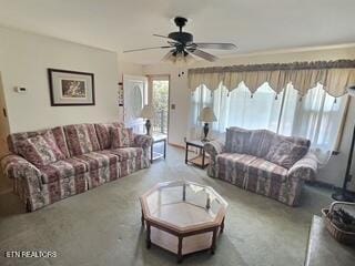 carpeted living room featuring ceiling fan