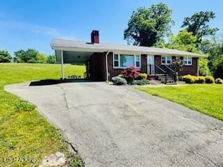 view of front of property with a carport and a front yard