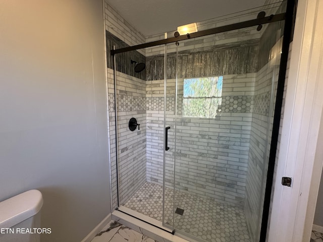 bathroom with an enclosed shower and toilet