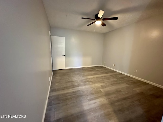 spare room featuring ceiling fan and dark hardwood / wood-style floors