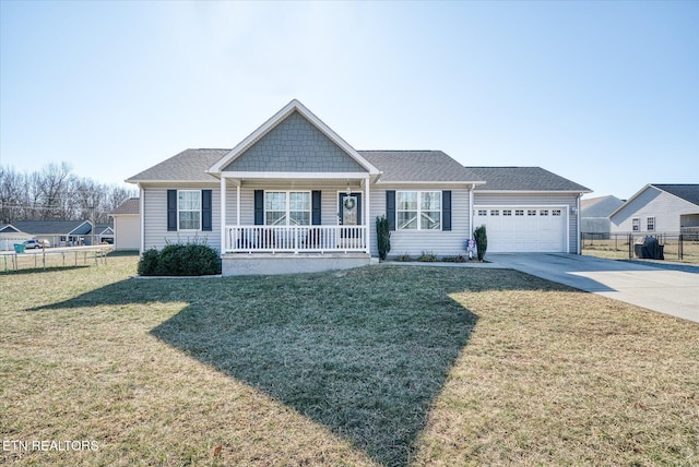 view of front of home with a garage, a front yard, and a porch