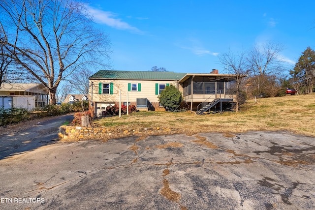 view of front of property with a sunroom