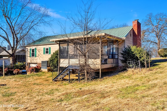 back of property featuring a yard