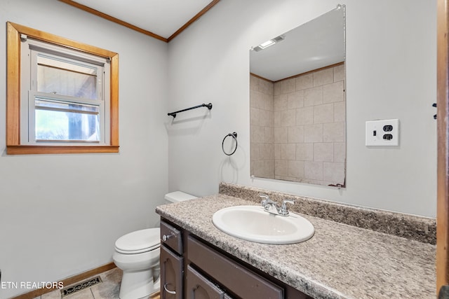 bathroom with tile patterned flooring, vanity, ornamental molding, and toilet