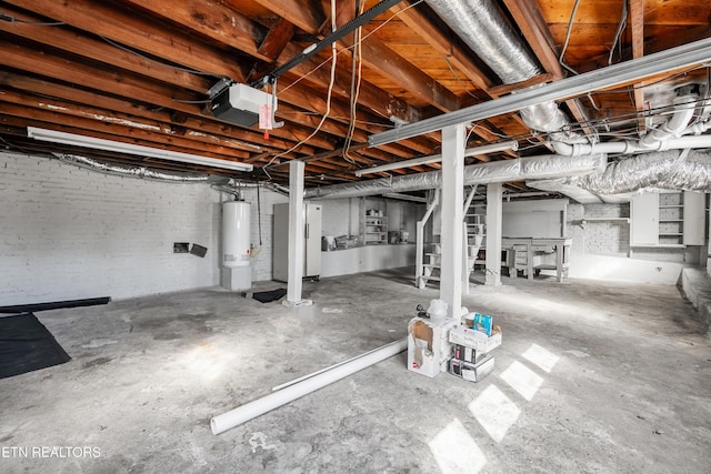 basement with brick wall and water heater