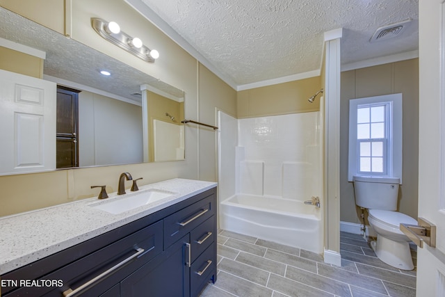 full bathroom with crown molding, shower / bath combination, vanity, a textured ceiling, and toilet