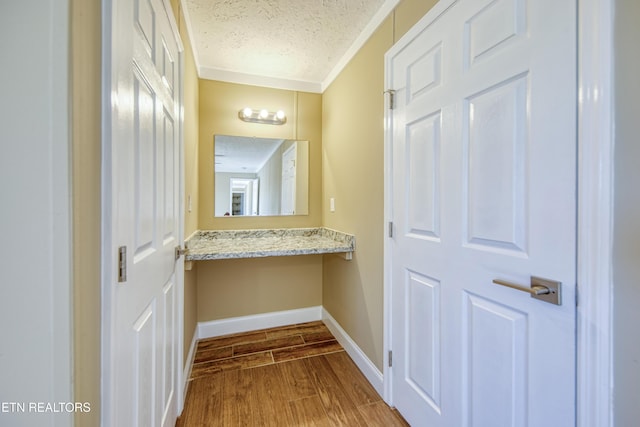 hall featuring crown molding and a textured ceiling