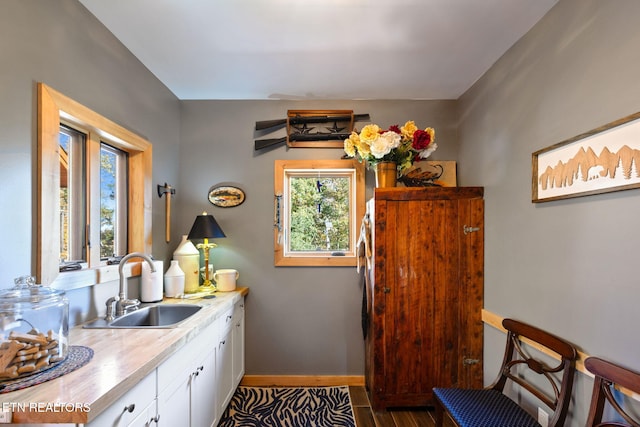 kitchen featuring sink and white cabinets