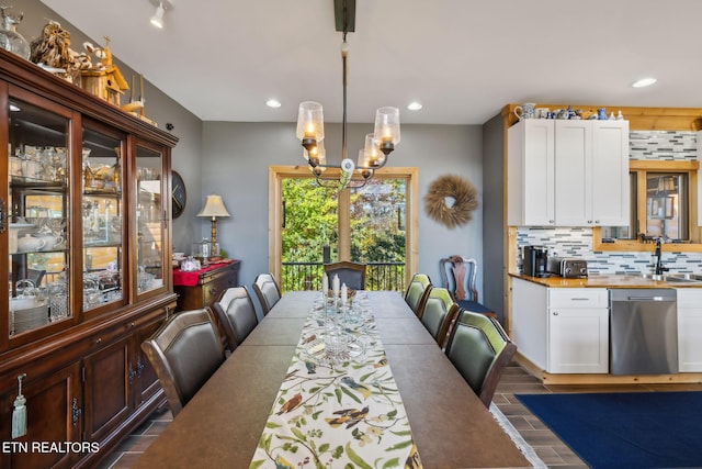 dining area with sink and a chandelier