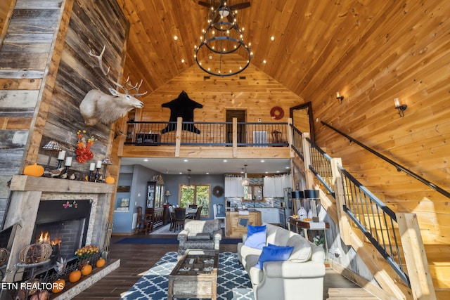 unfurnished living room featuring hardwood / wood-style flooring, a stone fireplace, high vaulted ceiling, and wooden ceiling