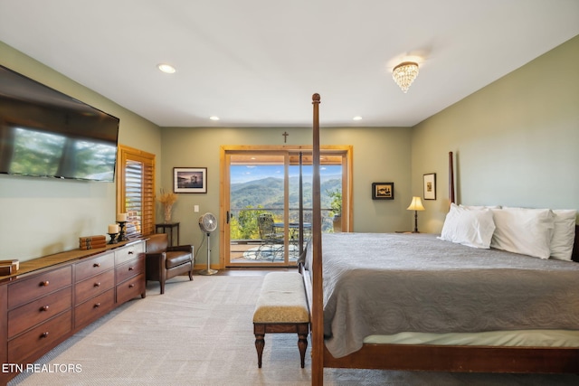 bedroom featuring multiple windows, access to outside, and light colored carpet