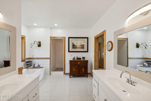 bathroom with plus walk in shower, tile patterned floors, and vanity