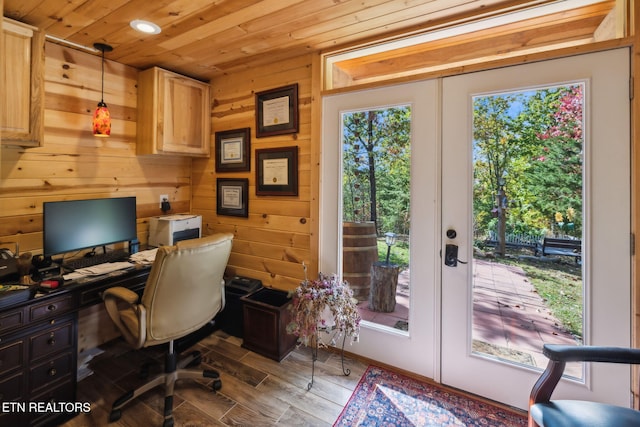 home office with wood ceiling, french doors, and wood walls