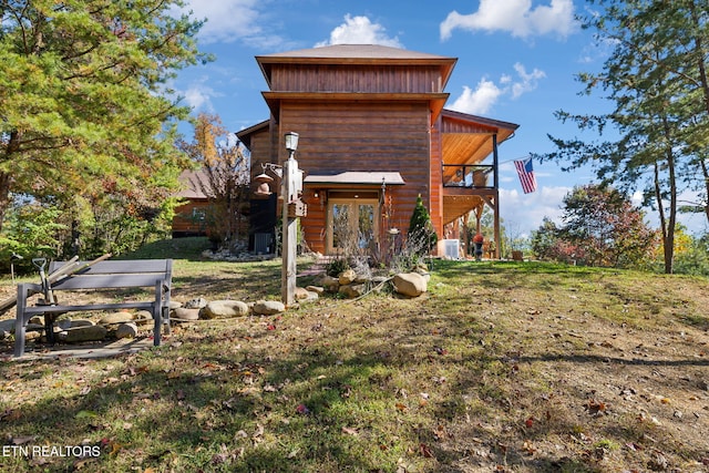 rear view of house featuring a yard and french doors