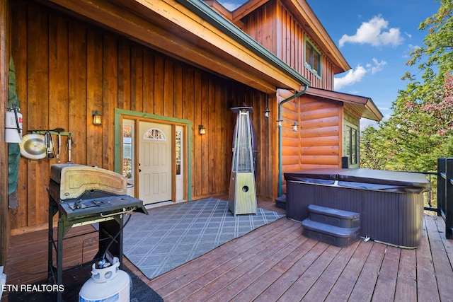 wooden deck featuring a hot tub