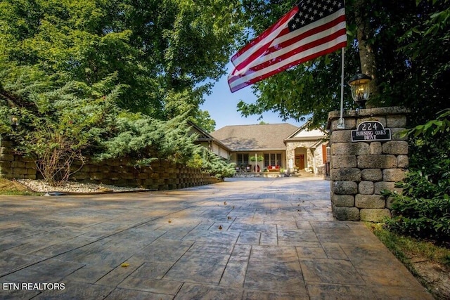 exterior space featuring decorative driveway