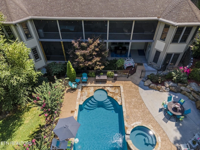 view of swimming pool with a patio area and an in ground hot tub